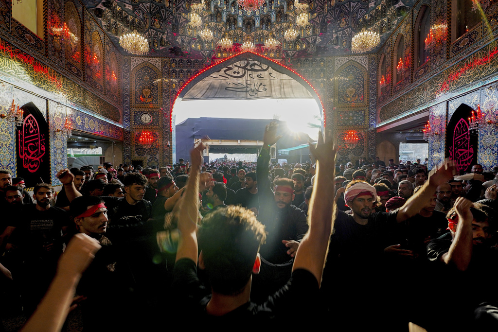 Shiite pilgrims participate in Arbaeen, which marks the end of the 40-day mourning period following Ashoura, in Karbala, Iraq, Thursday, Aug. 14, 2025. (AP Photo/Anmar Khalil)