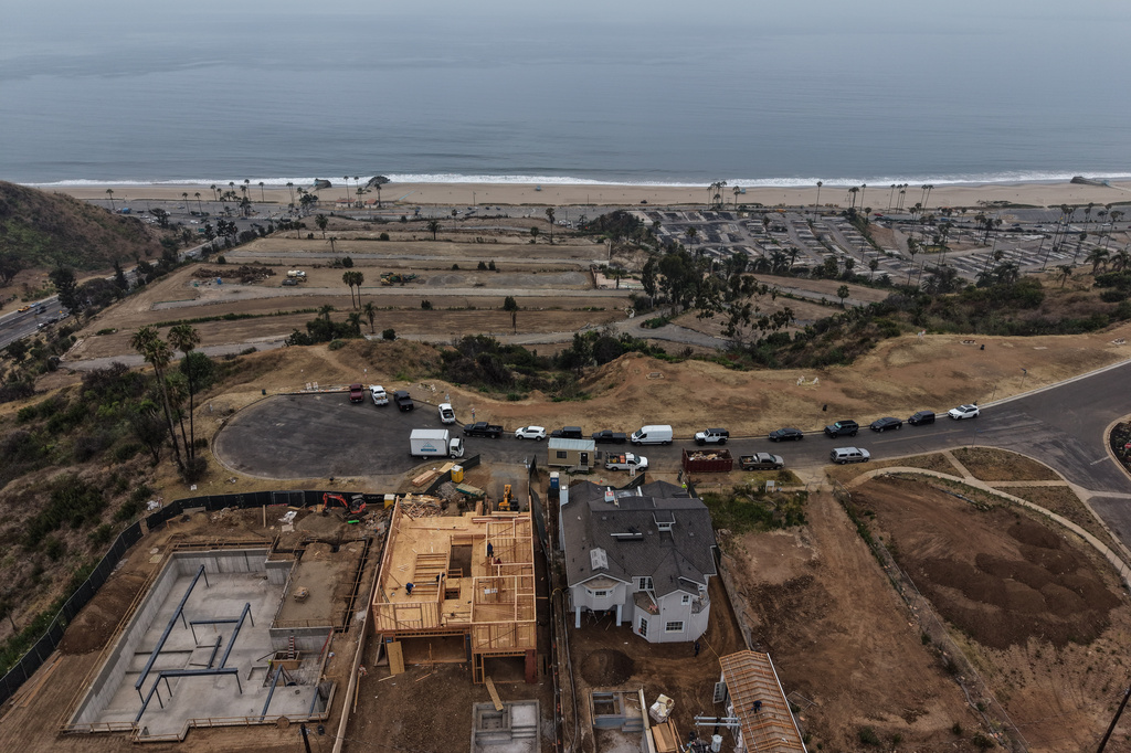 Homes under construction sit on a hillside overlooking the Pacific Ocean more than a year after the Palisades Fire in the Pacific Palisades neighborhood of Los Angeles, Thursday, June 4, 2026. (AP Photo/Jae C. Hong)