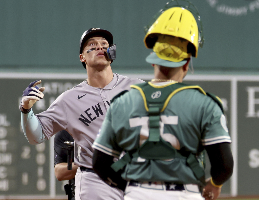New York Yankees designated hitter Aaron Judge, left, celebrates as he runs to home plate after hitting a home run during the first inning of a baseball game against the Boston Red Sox, Friday, Sept. 12, 2025, in Boston. (AP Photo/Mark Stockwell)