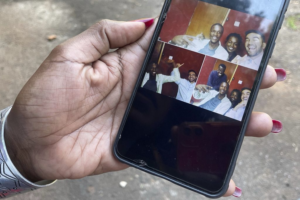Radio host Siima Kyakuhaire Sabiti shows old pictures of her with New York Mayor-elect Zohran Mamdani during his 2019 visit to her show in Kampala, Uganda, Wednesday, Nov. 5, 2025. (AP Photo/Hajarah Nalwadda )
