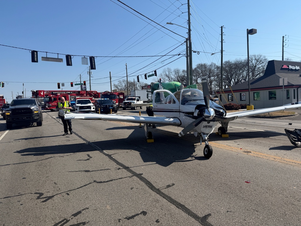 This image provided by Gainesville Police Department shows a small plane that made an emergency landing on a street in Gainesville, Ga., Monday, Feb. 9, 2026. (Gainesville, Ga., Police Department via AP)