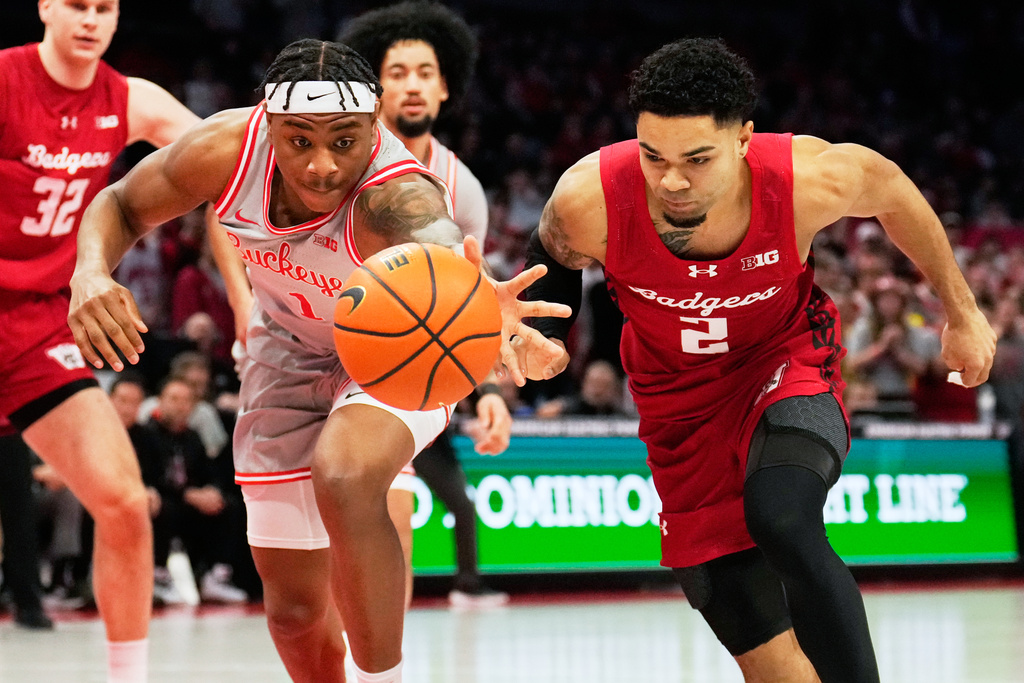 Ohio State forward Amare Bynum (1) and Wisconsin guard Nick Boyd(2) reach for the ball in the first half of an NCAA college basketball game Tuesday, Feb. 17, 2026, in Columbus, Ohio. (AP Photo/Sue Ogrocki)