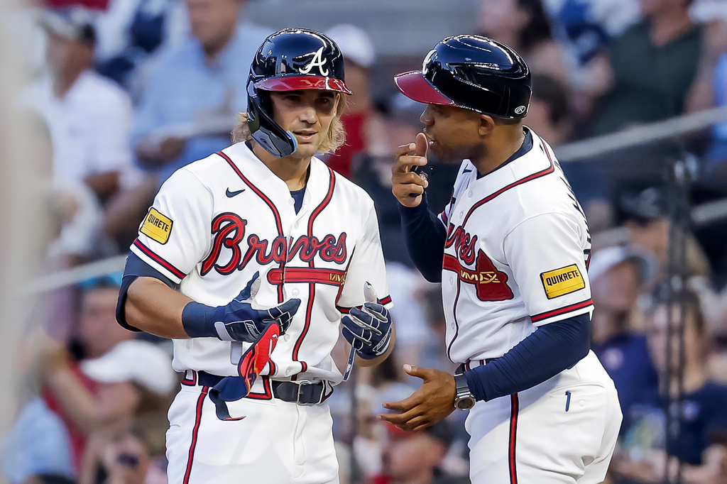Atlanta Braves' Jim Jarvis, left, reacts with first base coach Antoan Richardson, right, after hitting an RBI single against the New York Mets during the second inning of a baseball game, Monday, July 6, 2026, in Atlanta. (AP Photo/Erik S. Lesser)