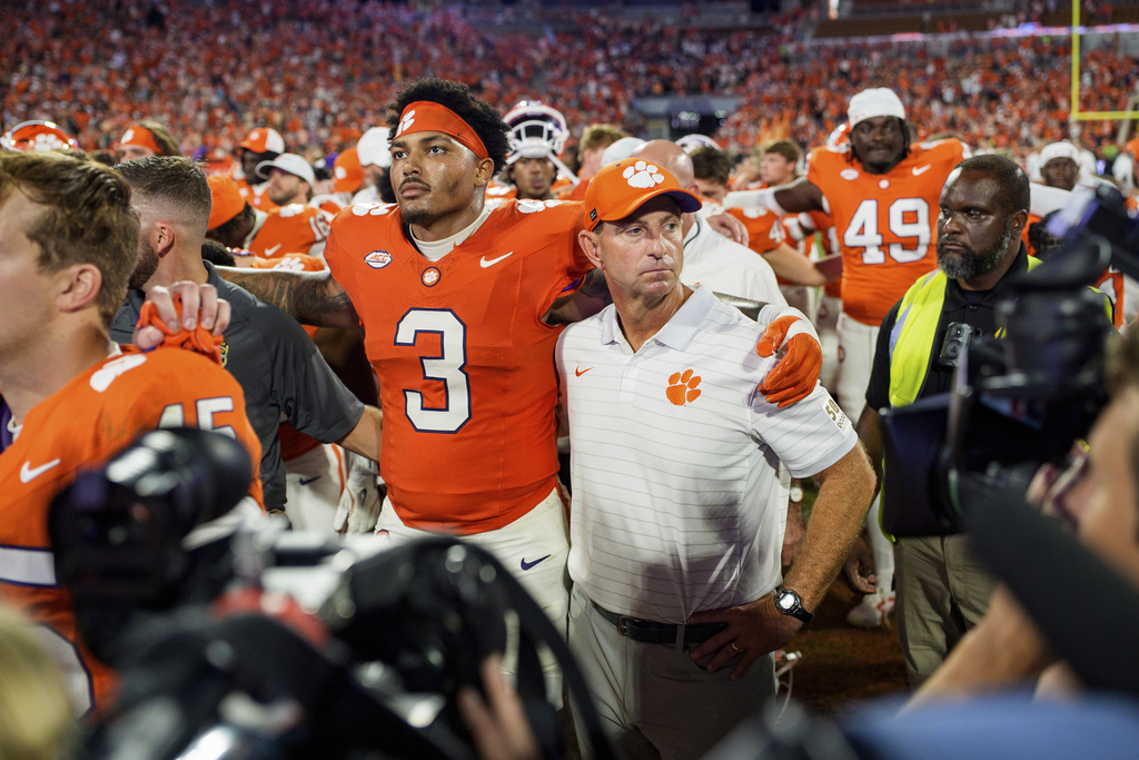 Clemson defensive end T.J. Parker (3) and Clemson head coach Dabo Swinney look on after losing to LSU in an NCAA college football game Saturday, Aug. 30, 2025, in Clemson, S.C. (AP Photo/Jacob Kupferman)