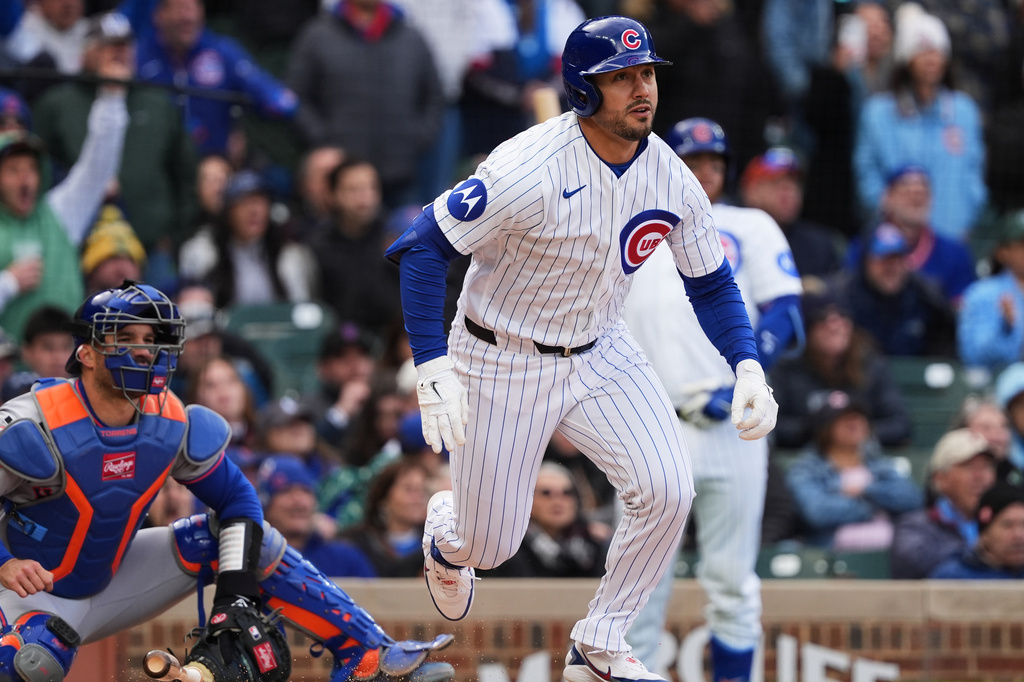 Chicago Cubs' Michael Conforto runs after hitting a one-run double during the ninth inning of a baseball game against the New York Mets in Chicago, Sunday, April 19, 2026. (AP Photo/Nam Y. Huh)