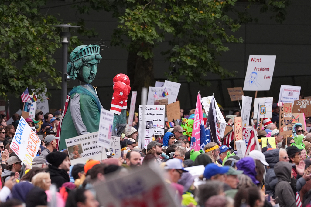 People take part in a "No Kings" protest Saturday, Oct. 18, 2025, in Seattle. (AP Photo/Lindsey Wasson)