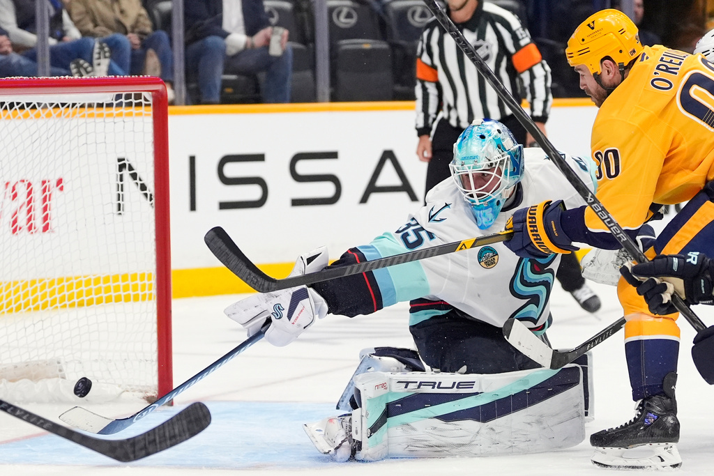 Nashville Predators center Ryan O'Reilly (90) scores a goal past Seattle Kraken goaltender Joey Daccord (35) during the second period of an NHL hockey game Thursday, March 19, 2026, in Nashville, Tenn. (AP Photo/George Walker IV)