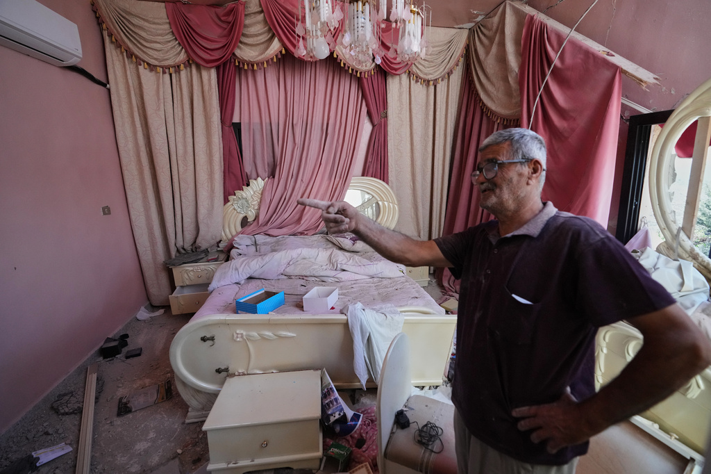 Mohammed Sobeih gestures inside his home, destroyed during the Israeli military operation, after returning to it in Zawtar al-Gharbieh, Lebanon, Tuesday, July 28, 2026. (AP Photo/Hassan Ammar)