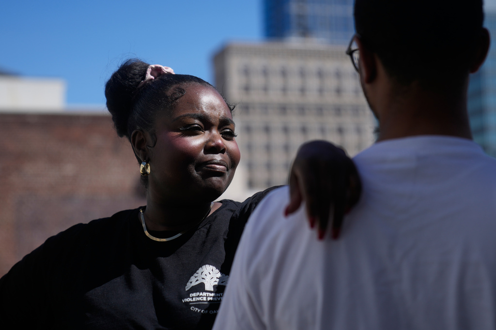 Oakland Ceasefire-Lifeline life coach LaSasha Long, left, poses for photos with Bernard C. during an interview Thursday, April 23, 2026, in Oakland, Calif. (AP Photo/Jeff Chiu)