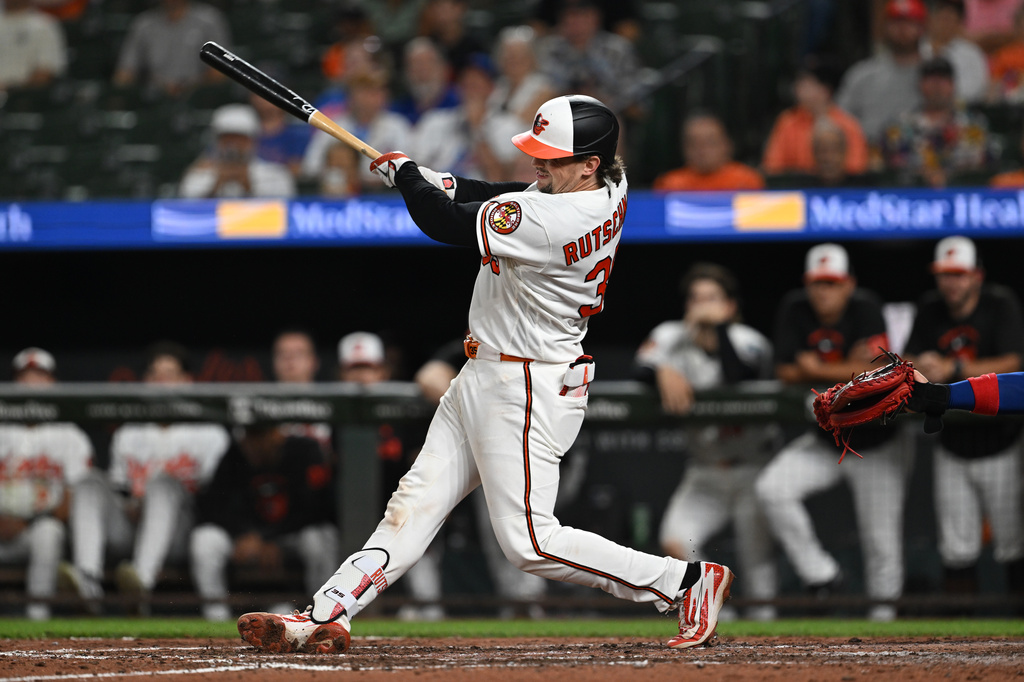 Baltimore Orioles catcher Adley Rutschman (35) follows through on a two run double against the Chicago Cubs in the seventh inning of a baseball game on Tuesday, July 7, 2026 in Baltimore, Md. (AP Photo/Gail Burton)