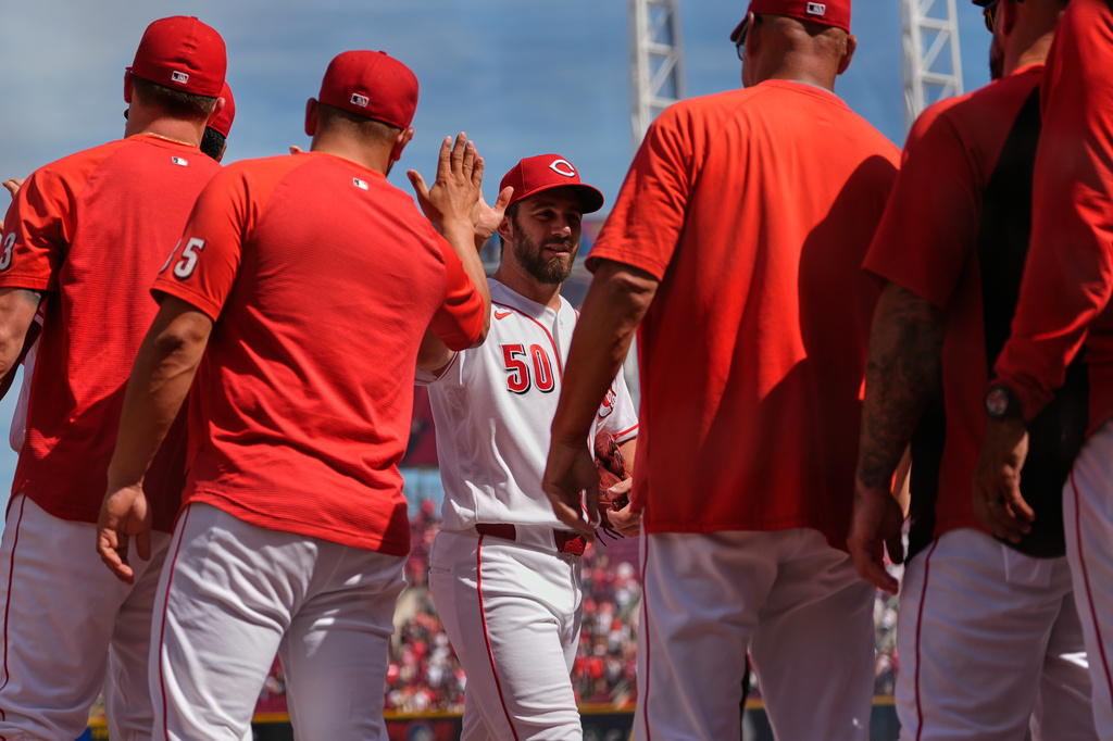 Cincinnati Reds pitcher Sam Moll is greeted as he walks off the field after winning a baseball game against the Atlanta Braves in Cincinnati, Sunday, May 31, 2026. (AP Photo/Carolyn Kaster)