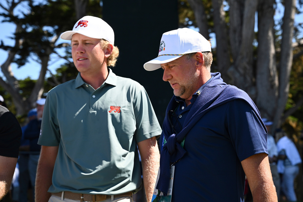 FILE - The Great Britain and Ireland team's Luke Poulter, left, walks with his father, Ian Poulter, during Walker Cup golf matches against the USA team at Cypress Point Club on Sept. 7, 2025, in Pebble Beach, Calif. (AP Photo/Thien-An Truong, File)