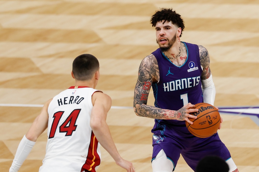 Charlotte Hornets guard LaMelo Ball (1) looks to shoot against Miami Heat guard Tyler Herro during the second half of an NBA basketball game, Tuesday, March 17, 2026, in Charlotte, N.C. (AP Photo/Nell Redmond)