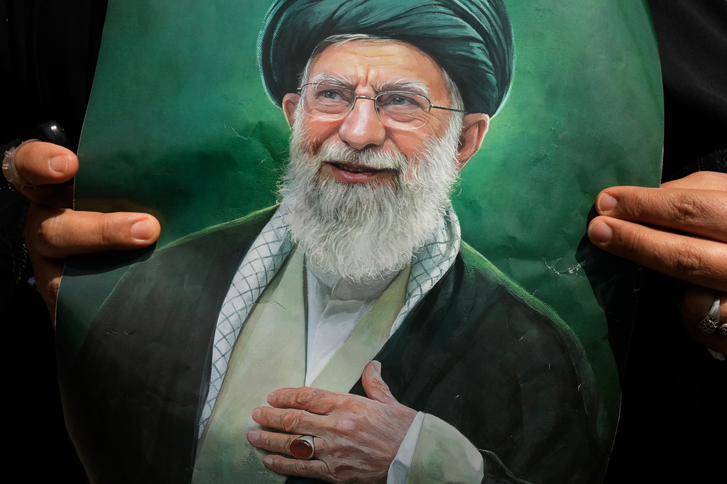 A woman holds a poster of the late Iranian Supreme Leader Ayatollah Ali Khamenei as she attends the dayslong funeral ceremonies for him and his family at the Imam Khomeini Mosalla Grand Mosque in Tehran, Iran, Saturday, July 4, 2026. (AP Photo/Vahid Salemi)