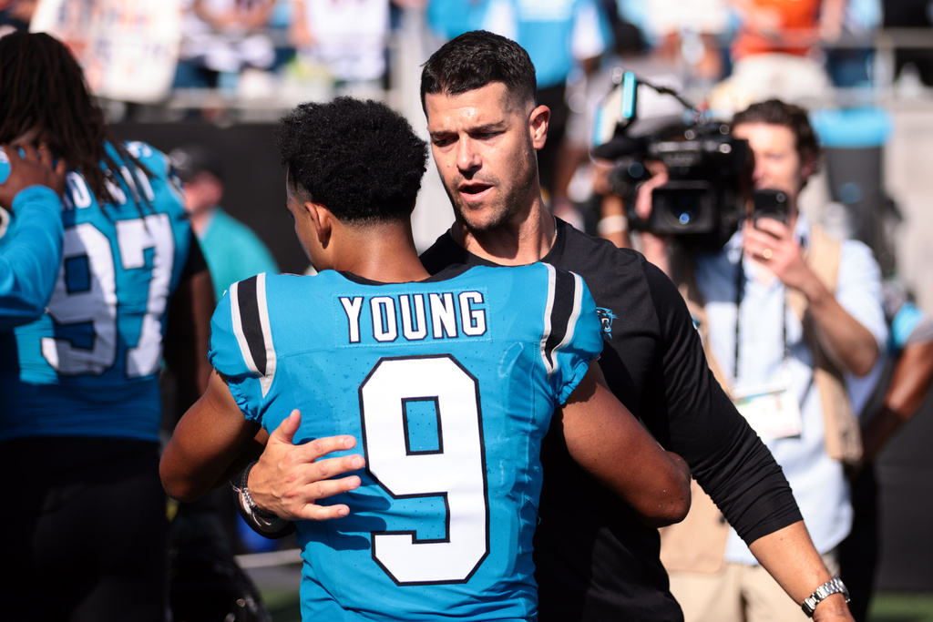 Carolina Panthers head coach Dave Canales embraces quarterback Bryce Young (9) after an NFL football game, Sunday, Sept. 13, 2026, in Charlotte, N.C. (AP Photo/Scott Kinser)