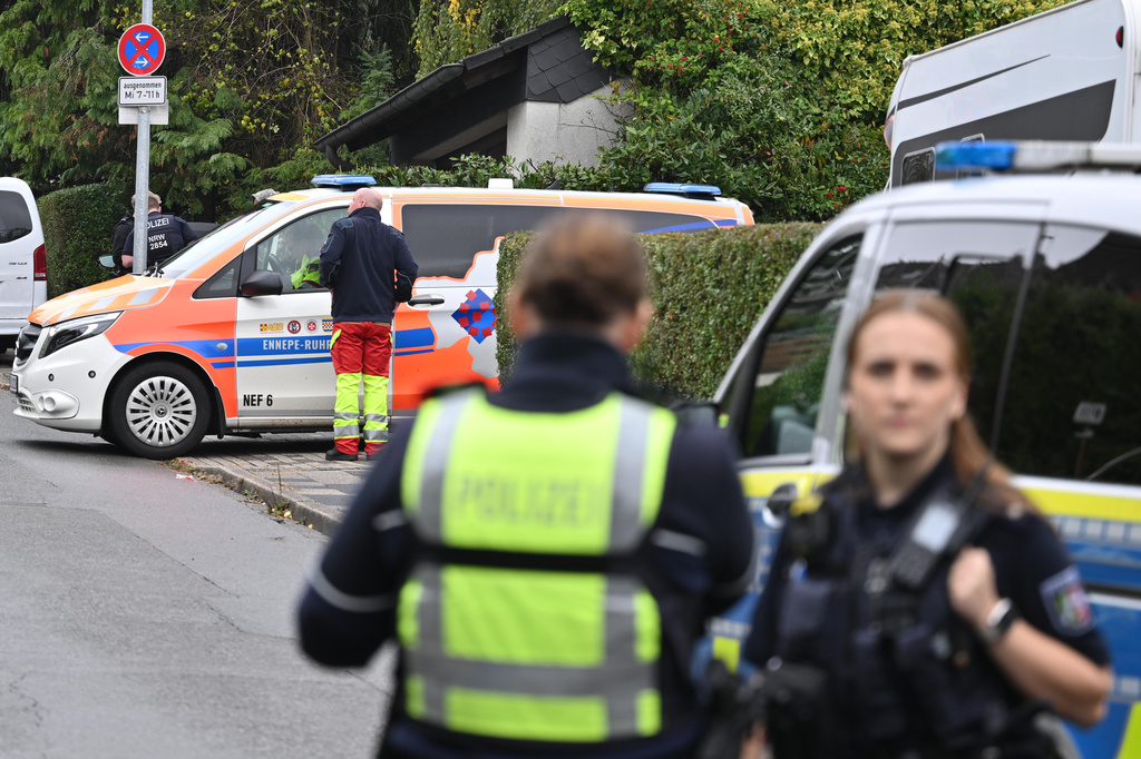 Police and emergency services stand on a street in Herdecke, Germany, Tuesday, Oct. 7, 2025, after the newly elected mayor of Herdecke, Iris Stalzer, has been found critically injured in her apartment. (Bernd Thissen/dpa via AP)