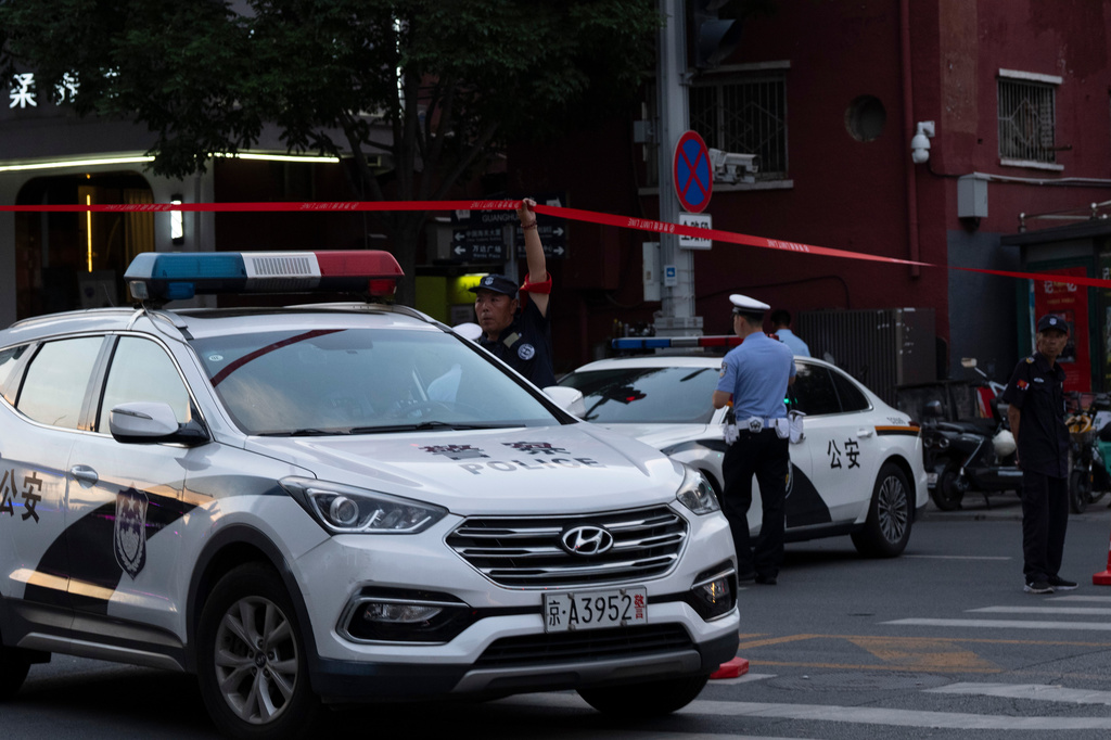 Police close off a road leading to the Citic Tower also known as Zun Tower after its facade was damaged in Beijing, Cina, Friday, June 26, 2026. (AP Photo/Han Guan Ng)