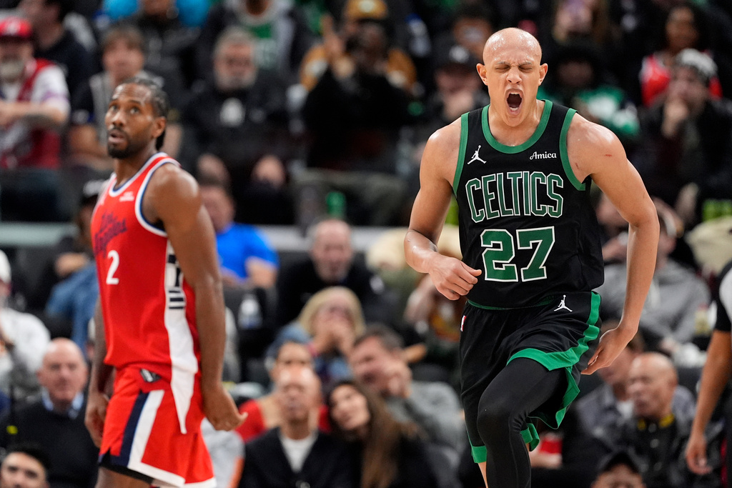 Boston Celtics guard Jordan Walsh, right, celebrates after scoring as Los Angeles Clippers forward Kawhi Leonard watches during the second half of an NBA basketball game Saturday, Jan. 3, 2026, in Inglewood, Calif. (AP Photo/Mark J. Terrill)