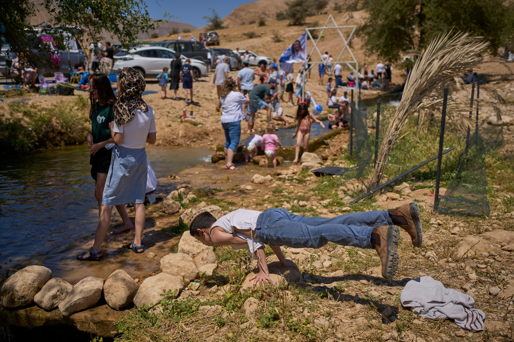 Israelis enjoy a day at a spring in Auja, in the Jordan Valley, during Israel's Independence Day on Wednesday, April 22, 2026, in the occupied West Bank. (AP Photo/Ohad Zwigenberg)