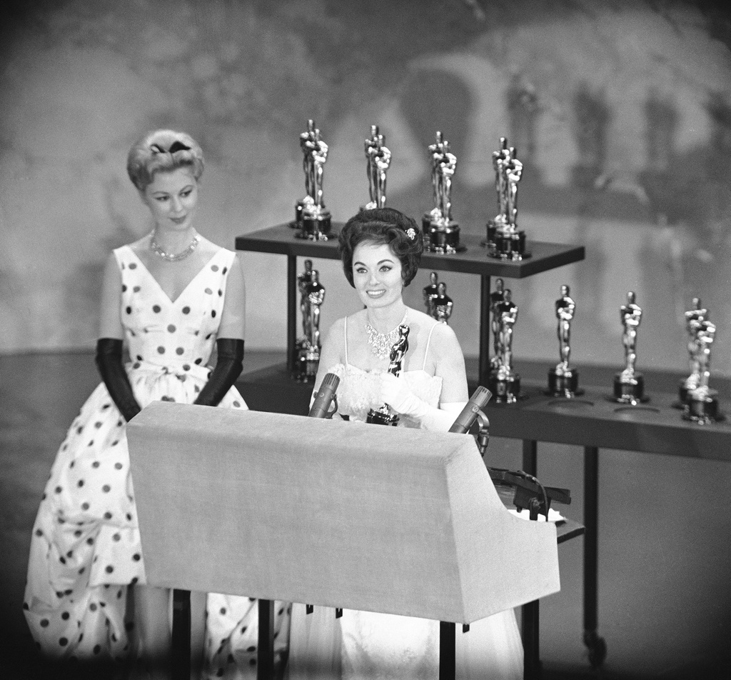 FILE - Actress Ann Blyth, right, holds the Oscar presented by the Motion Picture Academy for the best short subjects documentary, at right, is Mitzi Gaynor, in Hollywood, Calif April 4, 1960. (AP Photo, File)