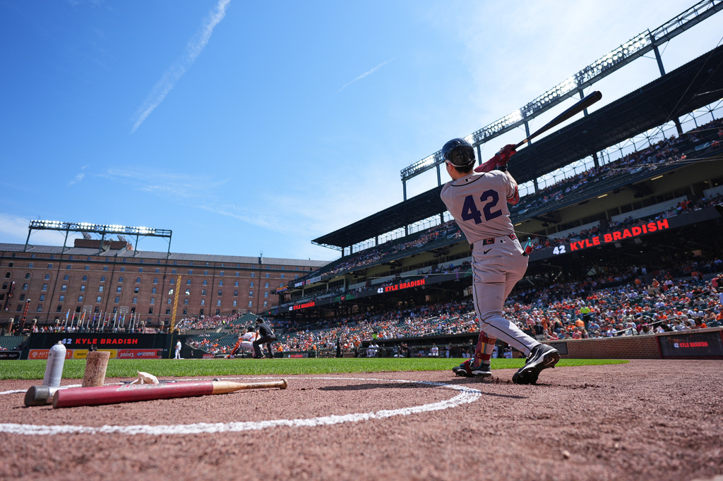 Arizona Diamondbacks' Corbin Carroll, wearing No. 42 to commemorate Jackie Robinson Day, swings in the on-deck circle before his at-bat during the first inning of a baseball game against the Baltimore Orioles, Wednesday, April 15, 2026, in Baltimore. (AP Photo/Stephanie Scarbrough)