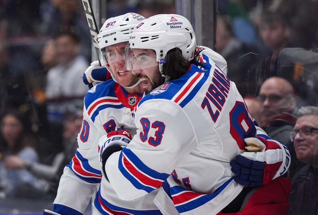 New York Rangers' Mika Zibanejad (93) and Will Cuylle celebrate Zibanejad's goal against the Vancouver Canucks during the first period of an NHL hockey game in Vancouver, on Tuesday, October 28, 2025. (Darryl Dyck/The Canadian Press via AP)