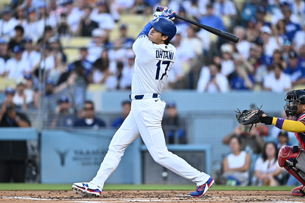 Los Angeles Dodgers' Shohei Ohtani hits a home run during the first inning of a baseball game against the Arizona Diamondbacks, Friday, July 10, 2026, in Los Angeles. (AP Photo/William Liang)