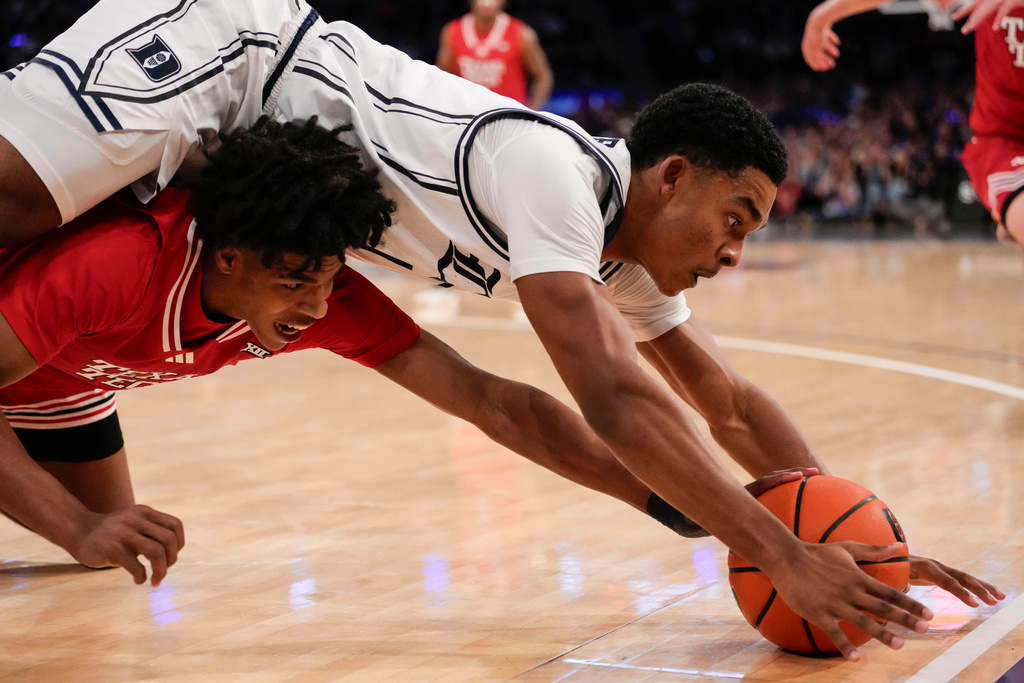 Duke guard Caleb Foster (1) fights for control of the ball with Texas Tech guard Christian Anderson (4) during the second half of an NCAA college basketball game, Saturday, Dec. 20, 2025, in New York. (AP Photo/Yuki Iwamura)