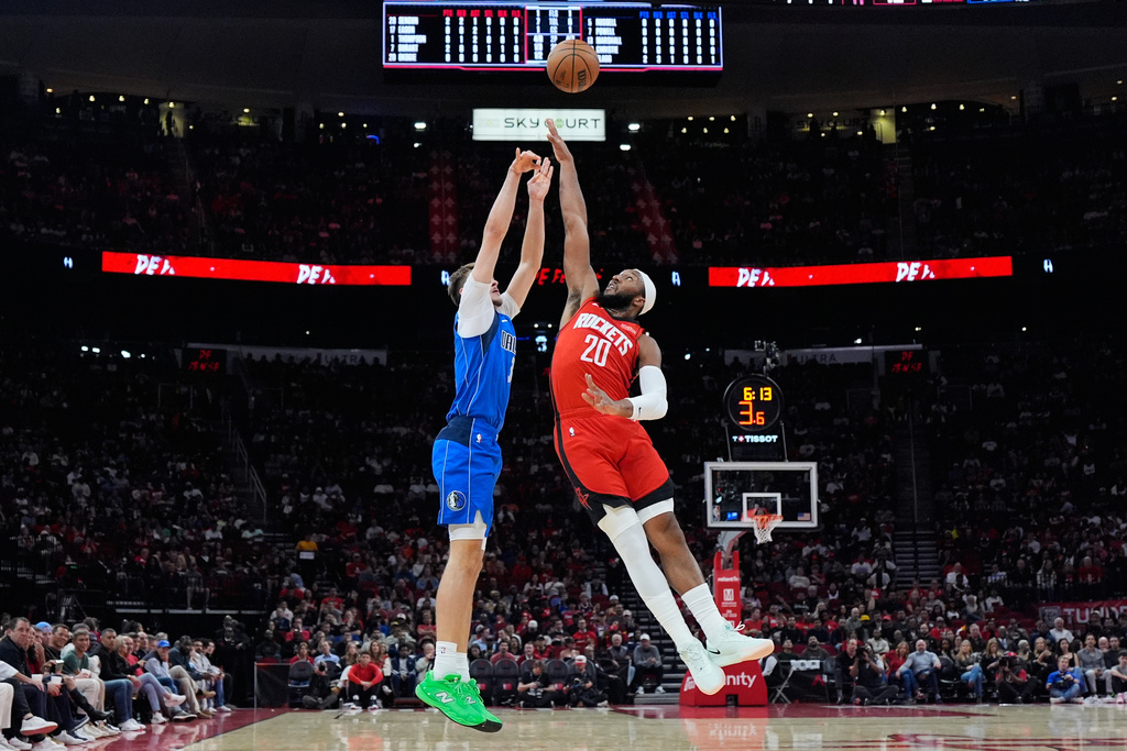 Dallas Mavericks forward Cooper Flagg (32) shoots against Houston Rockets guard Josh Okogie (20) during the first half of an NBA basketball game in Houston, Monday, Nov. 3, 2025. (AP Photo/Ashley Landis)