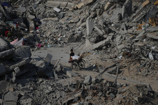 A boy pushes a wheelchair through the rubble of buildings destroyed in the war between Israel and Hamas, in the al-Nafaq area of the Sheikh Radwan neighborhood in Gaza City, Friday, Oct. 24, 2025. (AP Photo/Abdel Kareem Hana) A boy pushes a wheelchair through the rubble of buildings destroyed in the war between Israel and Hamas, in the al-Nafaq area of the Sheikh Radwan neighborhood in Gaza City, Friday, Oct. 24, 2025. (AP Photo/Abdel Kareem Hana)