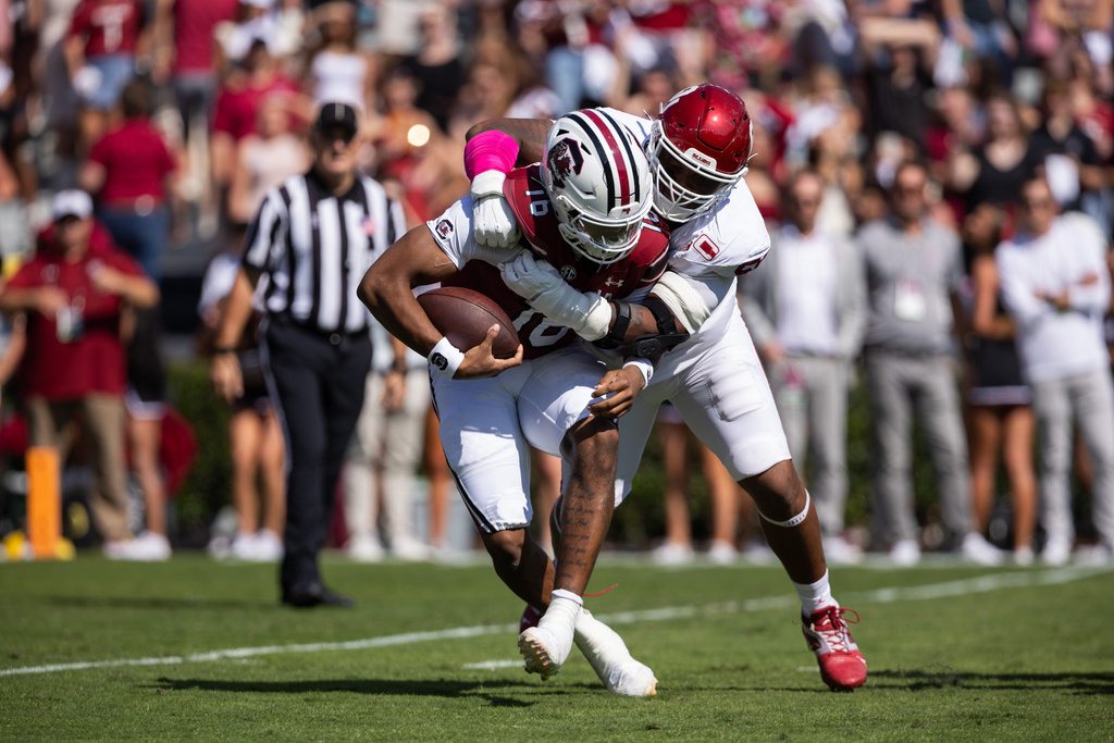 South Carolina quarterback Lanorris Sellers (16) gets sacked by Oklahoma defensive lineman Gracen Halton (56) during the first half of an NCAA college football game, Saturday, Oct. 18, 2025, in Columbia, S.C. (AP Photo/Scott Kinser)