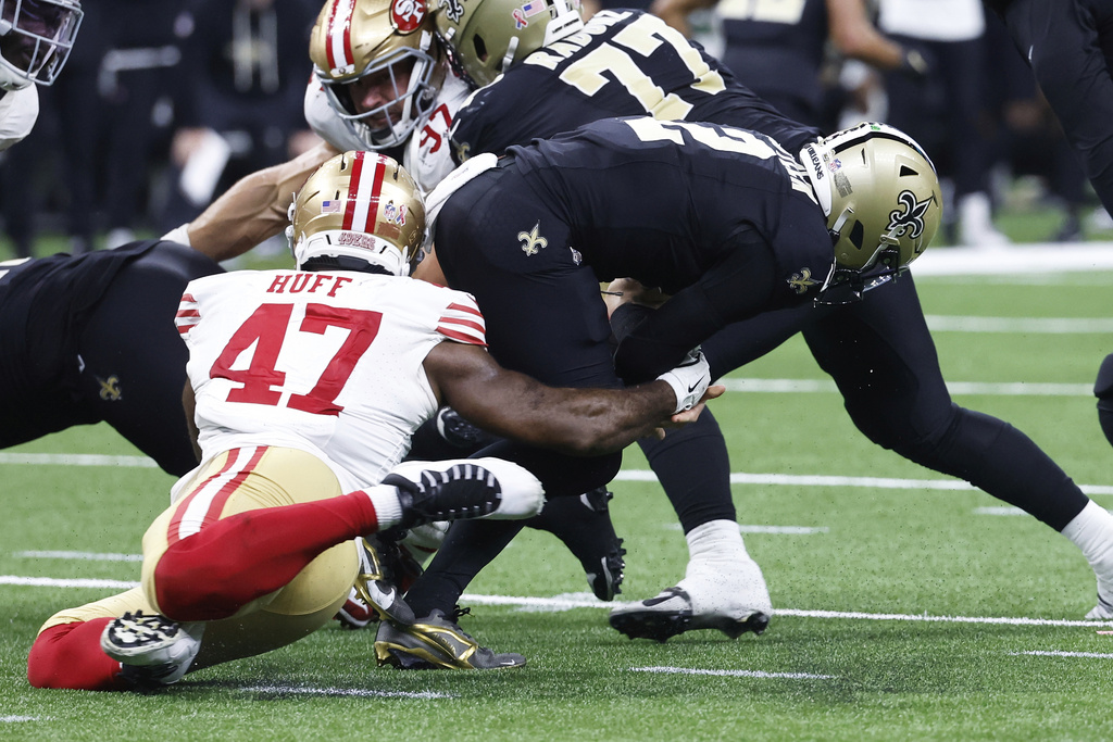 San Francisco 49ers defensive end Bryce Huff (47) sacks New Orleans Saints quarterback Spencer Rattler (2) and forces a fumble, which was recovered by the Saints but the ball changed possesion on downs, during the second half of an NFL football game in New Orleans, Sunday, Sept. 14, 2025. (AP Photo/Butch Dill)