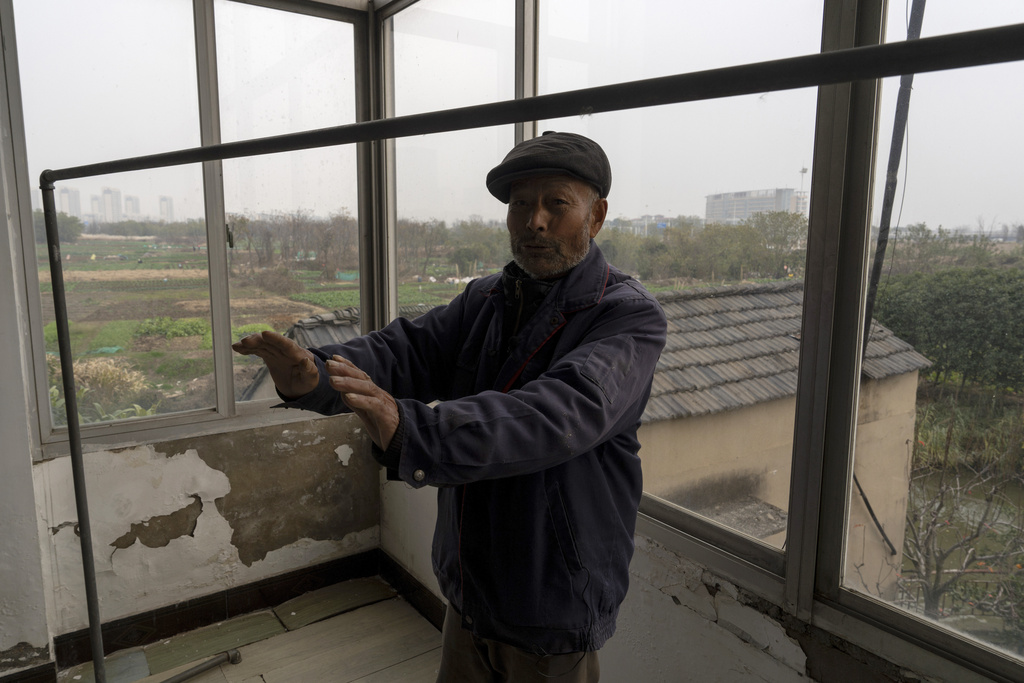 Petitioner Yang Guoliang talks about authorities bulldozing his lands during an interview in his home in Changzhou in eastern China's Jiangsu Province, Friday, Dec. 13, 2024. (AP Photo/Ng Han Guan)