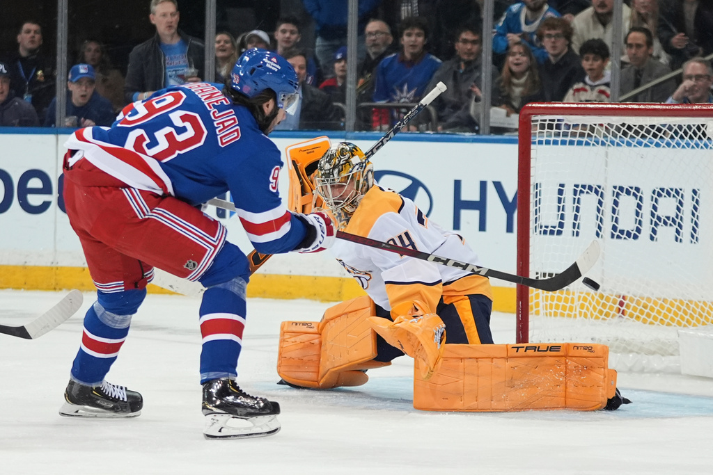 New York Rangers' Mika Zibanejad (93) shoots the puck past Nashville Predators goaltender Juuse Saros (74) during the first period of an NHL hockey game Monday, Nov. 10, 2025, in New York. (AP Photo/Frank Franklin II)