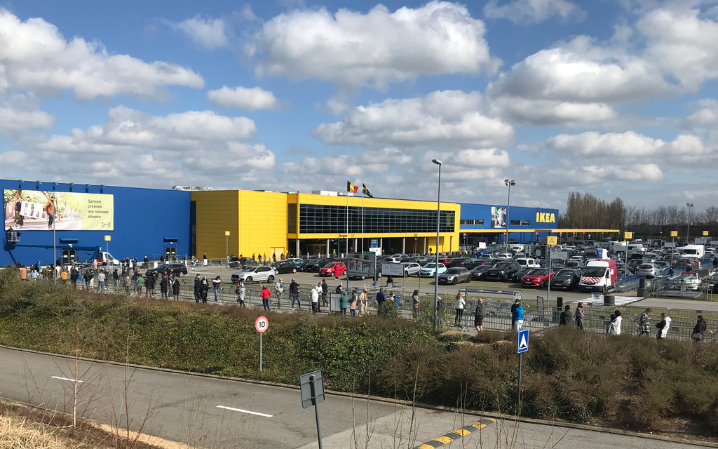 FILE- People stand in a line for last minute shopping outside an Ikea store in Brussels, Friday, March 26, 2021. (AP Photo/Mark Carlson, File)
