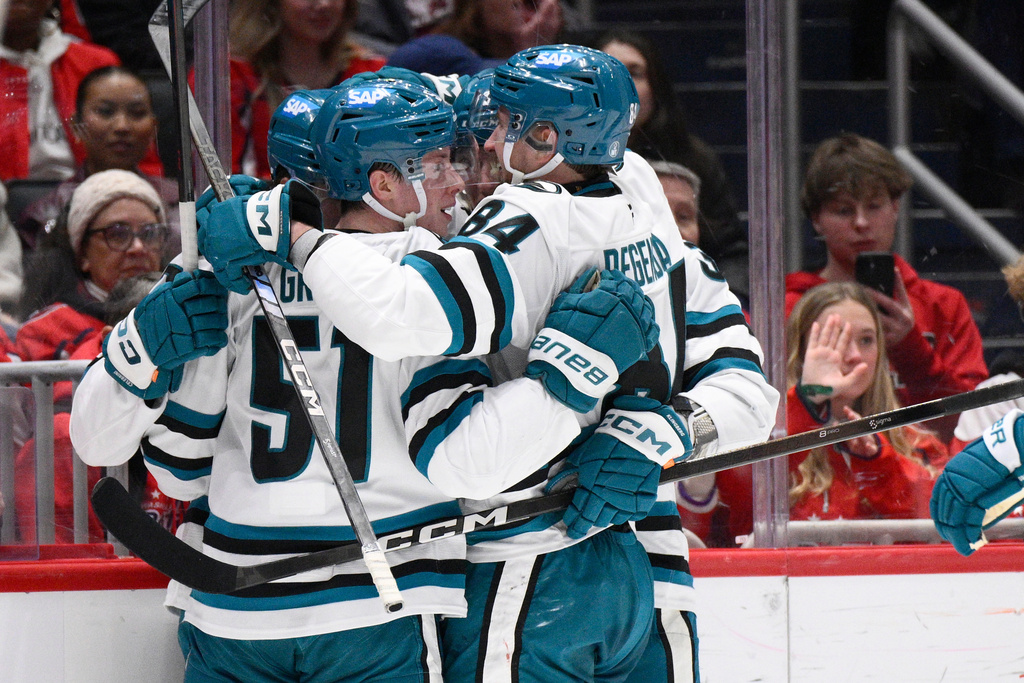 San Jose Sharks right wing Collin Graf (51) celebrates his goal with left wing Pavol Regenda (84) and others during the second period of an NHL hockey game against the Washington Capitals, Thursday, Jan. 15, 2026, in Washington. (AP Photo/Nick Wass)
