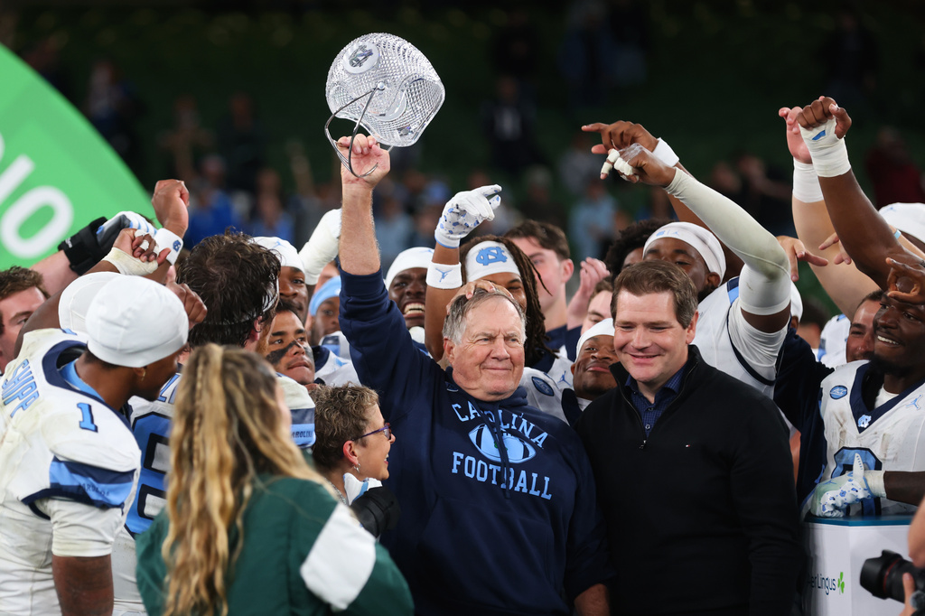 North Carolina head coach Bill Belichick, center, and his team celebrate after defeating TCU in an NCAA college football game in Dublin, Ireland, Saturday, Aug. 29, 2026. (AP Photo/Peter Morrison)