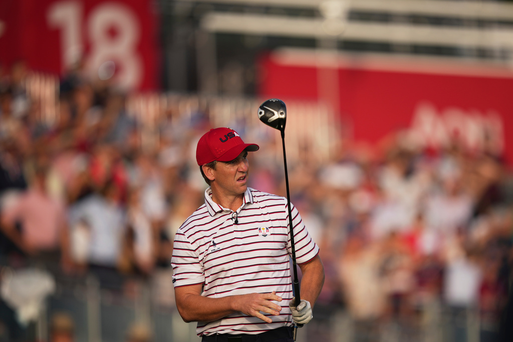 United States' Eli Manning watches his tee shot on the first hole during the celebrity Ryder Cup golf tournament, Wednesday, Sept. 24, 2025, on the Bethpage Black golf course, in Farmingdale, N.Y. (AP Photo/Matt Slocum)