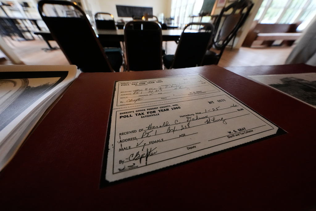 A copy of a poll tax receipt sits in the old schoolhouse meeting place, as part of the legacy of Vernon Dahmer, Sr., who was killed when the Ku Klux Klan firebombed the family home 1966, in Hattiesburg, Miss., Wednesday, June 3, 2026. (AP Photo/Gerald Herbert)