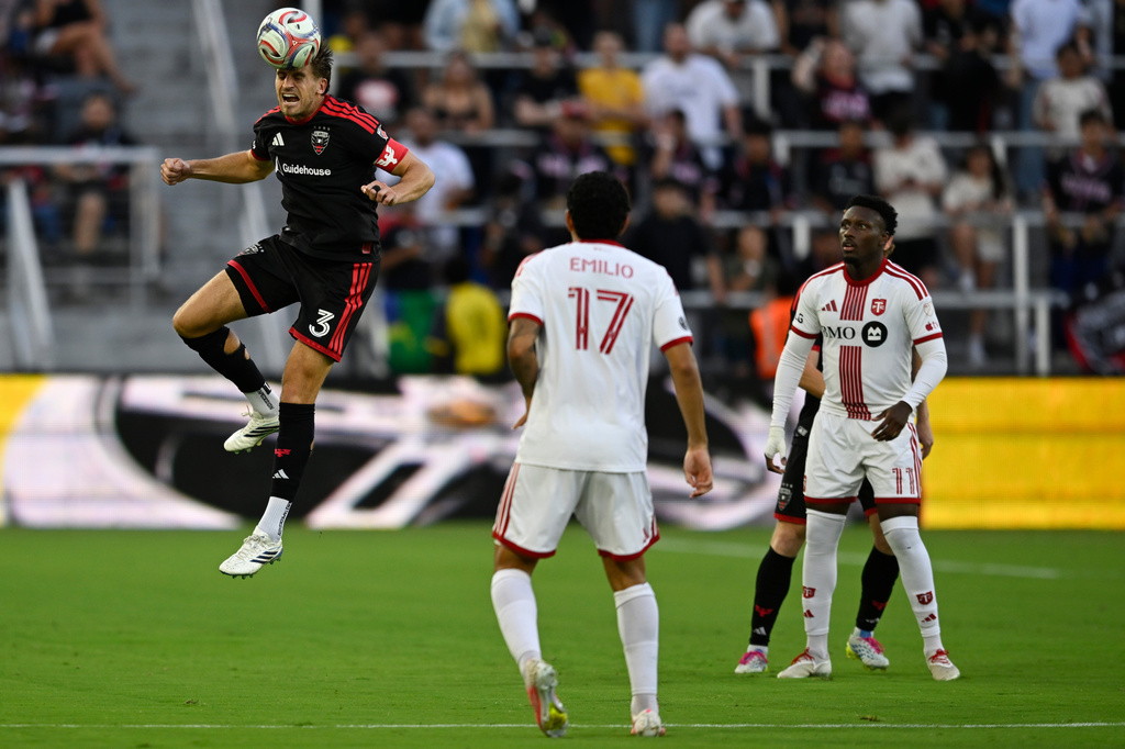 D.C. United defense Lucas Bartlett (3) heads the ball during the first half of an MLS soccer match against Toronto FC, Saturday, July 25, 2026, in Washington. (AP Photo/John McDonnell)