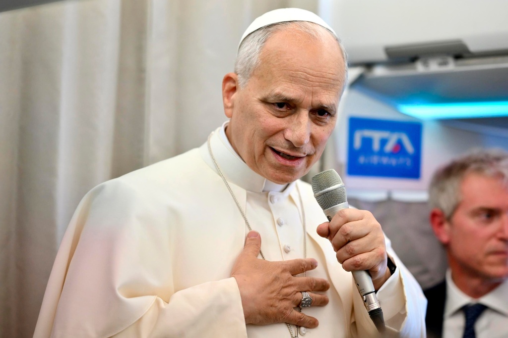Pope Leo XIV talks to reporters aboard an airplane as he returns from a six-day visit to Turkey and Lebanon, Tuesday, Dec. 2, 2025. (Alessandro Di Meo/Pool Photo via AP)