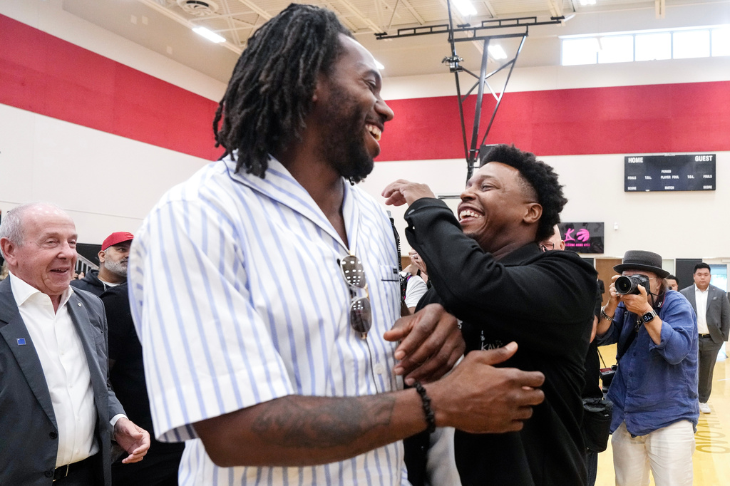 Kyle Lowry, right, speaks with Kawhi Leonard after a press conference in which Lowry signed a one-day contract to retire as a Toronto Raptor, in Toronto, on Tuesday, July 7, 2026. (Chris Young/The Canadian Press via AP)
