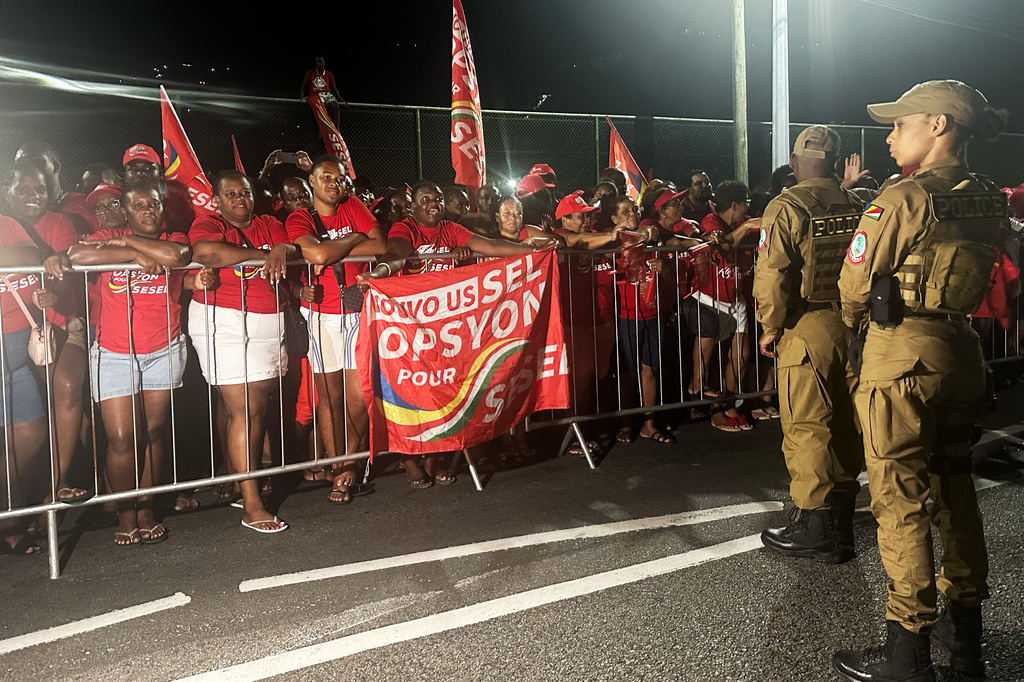 Supporters of President-elect Patrick Herminie celebrate after his winning in the runoff presidential election outside the Electoral Commision Headquarters in Victoria, Seychelles on Sunday, Oct. 12, 2025. (AP Photo/Emilie Chetty)