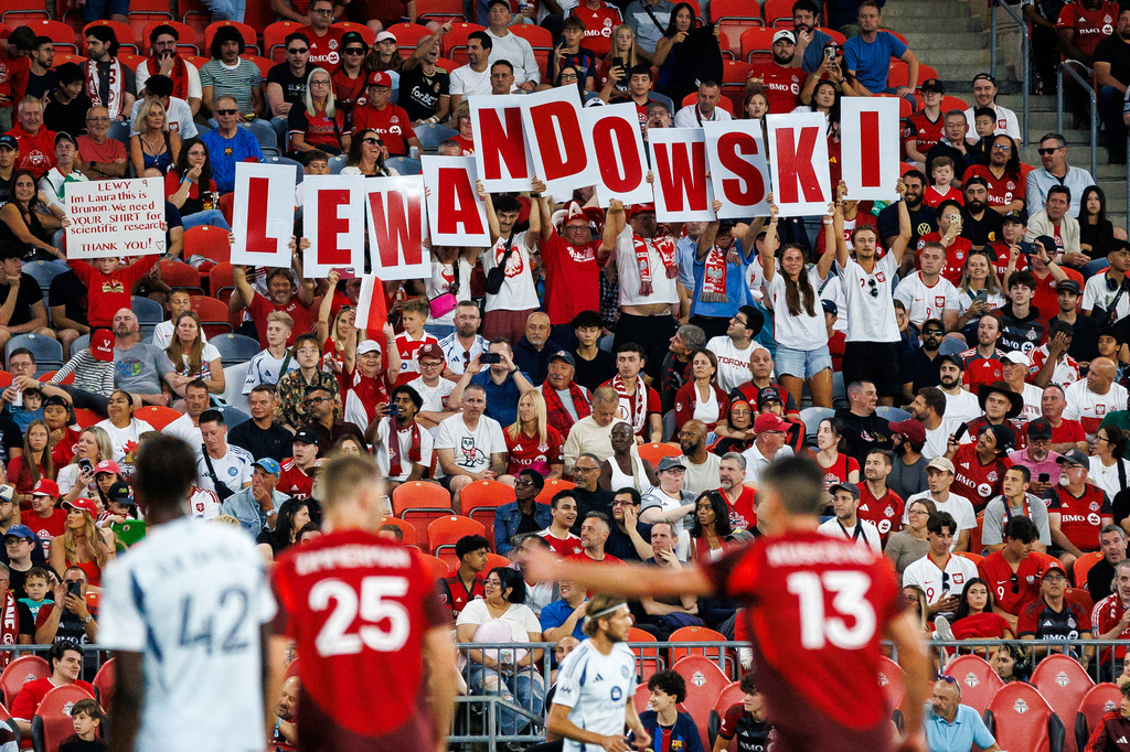 Fans hold up signs for Chicago Fire FC's Robert Lewandowski (9) during first half MLS soccer action between Toronto FC and Chicago Fire FC in Toronto, Saturday, Sept. 5, 2026. (Keito Newman/The Canadian Press via AP)