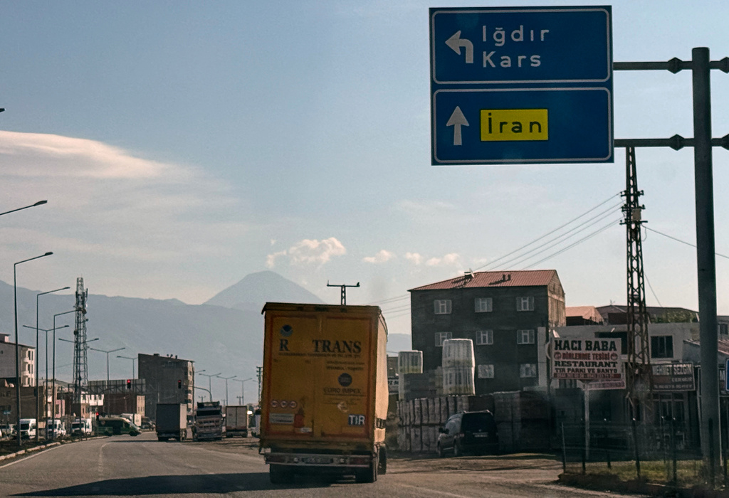 Trucks drive on the road leading to the Gurbulak border crossing on the Turkish-Iranian border in Agri province, eastern Turkey, Tuesday, Sept. 22, 2026. (AP Photo/Serra Yedikardes)