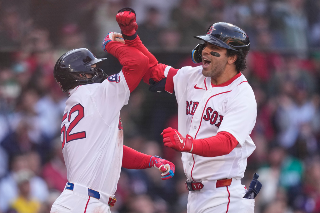 Boston Red Sox's Marcelo Mayer, right, celebrates with Wilyer Abreu (52) after his two-run home run against the San Diego Padres during the sixth inning of the home-opener baseball game at Fenway Park, Friday, April 3, 2026, in Boston. (AP Photo/Charles Krupa)
