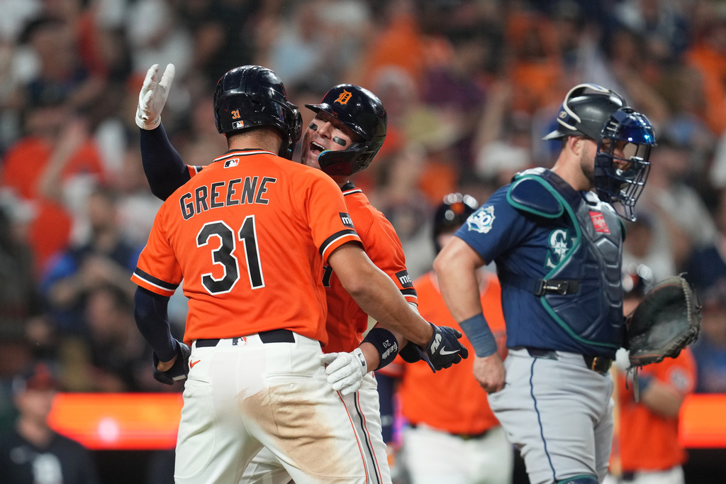 Detroit Tigers' Spencer Torkelson celebrates his two-run home run with Riley Greene (31) as Seattle Mariners catcher Mitch Garver, right, looks on during the eighth inning of a baseball game Friday, June 5, 2026, in Detroit. (AP Photo/Paul Sancya)