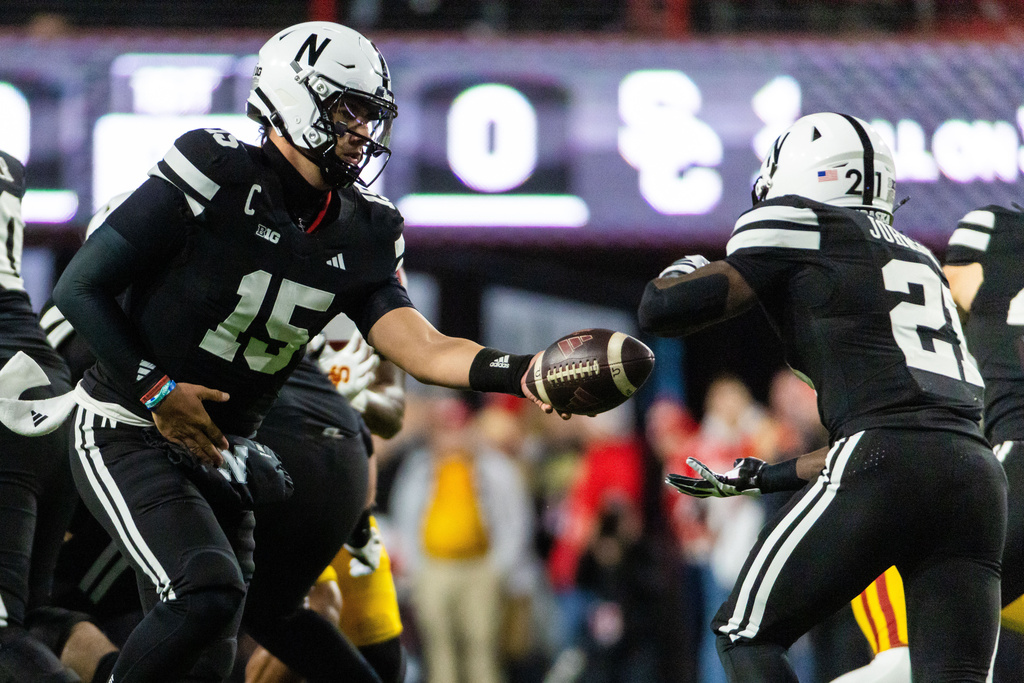 Nebraska quarterback Dylan Raiola (15) hands off the ball to running back Emmett Johnson (21) during the first half of an NCAA college football game, Saturday, Nov. 1, 2025, in Lincoln, Neb. (AP Photo/Bonnie Ryan)