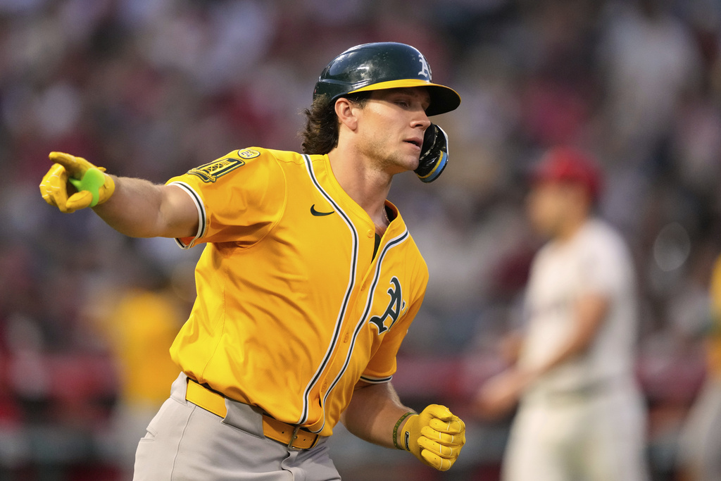 Athletics' Colby Thomas gestures toward his dugout as he heads to first for a three-run home run as Los Angeles Angels pitcher Yusei Kikuchi stands on the mound during the second inning of a baseball game Saturday, Sept. 6, 2025, in Anaheim, Calif. (AP Photo/Mark J. Terrill)