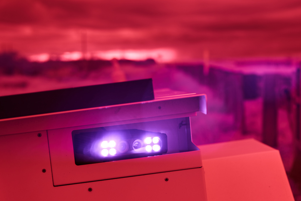 An infrared beam of light shines out of an automatic license plate reader recording vehicles passing along U.S. Highway 83, Oct. 13, 2025, in Laredo, Texas. (AP Photo/David Goldman)